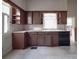 Kitchen with dark wood cabinets and a dishwasher at 222 Leak Ave, Wadesboro, NC 28170