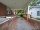 Brick walkway leads to side yard with gravel at 222 Leak Ave, Wadesboro, NC 28170