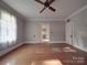 Spacious living room with hardwood floors and two doors at 222 Leak Ave, Wadesboro, NC 28170