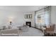 Cozy living room featuring a corner fireplace and large windows at 210 Giant Oak Ave, Statesville, NC 28677