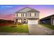 Two-story home with stone and beige siding at 210 Giant Oak Ave, Statesville, NC 28677