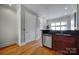 Small galley kitchen with stainless steel dishwasher and dark wood cabinets at 701 N Church St # 3, Charlotte, NC 28202