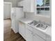 Kitchen with white cabinets, stainless steel sink, and dishwasher at 1024 Mcarthur Ave, Charlotte, NC 28206