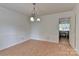 Spacious dining room with hardwood floors and access to kitchen at 13901 Phillips Rd, Matthews, NC 28105