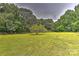 Spacious backyard with a split rail fence and lush green grass at 13901 Phillips Rd, Matthews, NC 28105