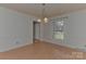 Bright dining room with hardwood floors and chandelier at 13901 Phillips Rd, Matthews, NC 28105