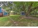 Large backyard with stone path and large tree at 13901 Phillips Rd, Matthews, NC 28105