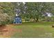 Blue storage shed in backyard with green lawn at 13901 Phillips Rd, Matthews, NC 28105