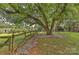 Landscaped backyard with mature trees and wood fence at 13901 Phillips Rd, Matthews, NC 28105