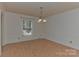 Simple dining room with hardwood floors and chandelier at 13901 Phillips Rd, Matthews, NC 28105