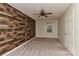 Bedroom with ceiling fan and wood-like accent wall at 13901 Phillips Rd, Matthews, NC 28105