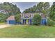 Charming blue house with a yellow door, two-car garage, and well-maintained lawn at 13901 Phillips Rd, Matthews, NC 28105