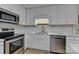 Modern kitchen with white cabinets and stainless steel appliances at 13901 Phillips Rd, Matthews, NC 28105