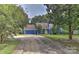 Blue house with yellow door and attached garage at 13901 Phillips Rd, Matthews, NC 28105