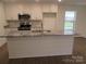 Kitchen island with granite countertop and white cabinets at 1452 Ole Cambridge Cir, Clover, SC 29710