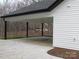 Covered carport with concrete flooring and wooded backdrop at 3910 Jenkins Rd, Clover, SC 29710