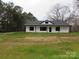 White house with black accents and a spacious lawn at 3910 Jenkins Rd, Clover, SC 29710