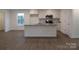 Modern kitchen with white cabinets, granite countertops, and stainless steel appliances at 3910 Jenkins Rd, Clover, SC 29710