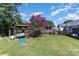 Landscaped backyard with a swing set and flowering crape myrtle tree at 4012 Watson Church Rd, Monroe, NC 28110