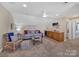 Spacious bonus room with wet bar and comfortable seating at 7567 Baybrooke Ln # 35, Harrisburg, NC 28075