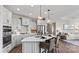 Modern kitchen with island, stainless steel appliances, and white cabinetry at 7567 Baybrooke Ln # 35, Harrisburg, NC 28075