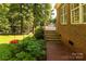 Landscaped backyard with deck and brick walkway at 4709 Trey View Ct, Mint Hill, NC 28227