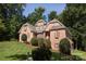 Brick home with lush landscaping on a sloped lot at 4709 Trey View Ct, Mint Hill, NC 28227