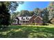 Brick home nestled on a hill with a large yard and mature trees at 926 Courtney Ct, Concord, NC 28025