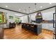 Open concept kitchen with island seating, hardwood floors, and a view of dining area at 400 Ferrell Ave, Belmont, NC 28012