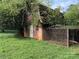 Brick building overgrown with vines and chain link fence at 4539 S New Hope Rd, Gastonia, NC 28056