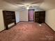 Spacious bonus room with built-in shelving and carpet flooring at 4539 S New Hope Rd, Gastonia, NC 28056