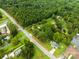 Aerial view showing house, pond, and surrounding woods at 4539 S New Hope Rd, Gastonia, NC 28056