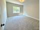 Well-lit bedroom with carpeted floors and a window at 310 Scalybark Trl, Concord, NC 28027