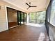 Spacious screened porch with sliding glass doors and a view of the backyard at 310 Scalybark Trl, Concord, NC 28027