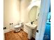 Modern powder room with pedestal sink and hardwood floors at 310 Scalybark Trl, Concord, NC 28027