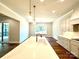 Modern kitchen with white cabinets, quartz countertops and a large island at 310 Scalybark Trl, Concord, NC 28027