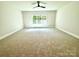 Spacious bedroom with carpeted floors and a large window at 310 Scalybark Trl, Concord, NC 28027