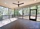 Relaxing screened porch with ceiling fan and wooded views at 310 Scalybark Trl, Concord, NC 28027