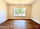 Elegant dining room with hardwood floors and a large window at 310 Scalybark Trl, Concord, NC 28027