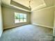 Comfortable bedroom with carpeted floors and a large window at 310 Scalybark Trl, Concord, NC 28027
