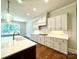 Modern kitchen with white cabinets and a large island at 310 Scalybark Trl, Concord, NC 28027