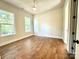 Bedroom with hardwood floors and two large windows at 310 Scalybark Trl, Concord, NC 28027