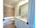 Clean bathroom, featuring a white vanity and tile shower/tub combo at 310 Scalybark Trl, Concord, NC 28027