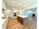 Modern kitchen with island and stainless steel appliances at 310 Scalybark Trl, Concord, NC 28027