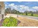 View of quiet street with manicured lawns and clubhouse in background at 5011 Valor Ln, Mint Hill, NC 28227