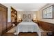Bedroom with a built-in wooden shelving unit and large bed at 4120 Statesville Blvd, Salisbury, NC 28147
