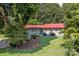 Ranch home with red metal roof, landscaping, and a two-car garage at 4120 Statesville Blvd, Salisbury, NC 28147