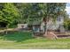 Ranch house with stone retaining wall and mature trees at 4120 Statesville Blvd, Salisbury, NC 28147