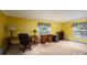 Bedroom with yellow walls, carpeted floors, and ample natural light at 512 Battleground Rd, Lincolnton, NC 28092