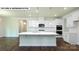 Modern kitchen with white cabinets, center island, and hardwood floors at 115 Saidin Ln, Troutman, NC 28166